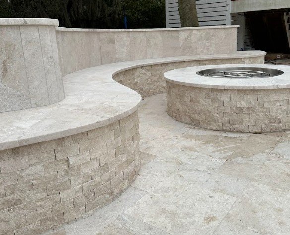 A stone patio featuring a cozy fire pit surrounded by comfortable seating, ideal for outdoor gatherings and relaxation